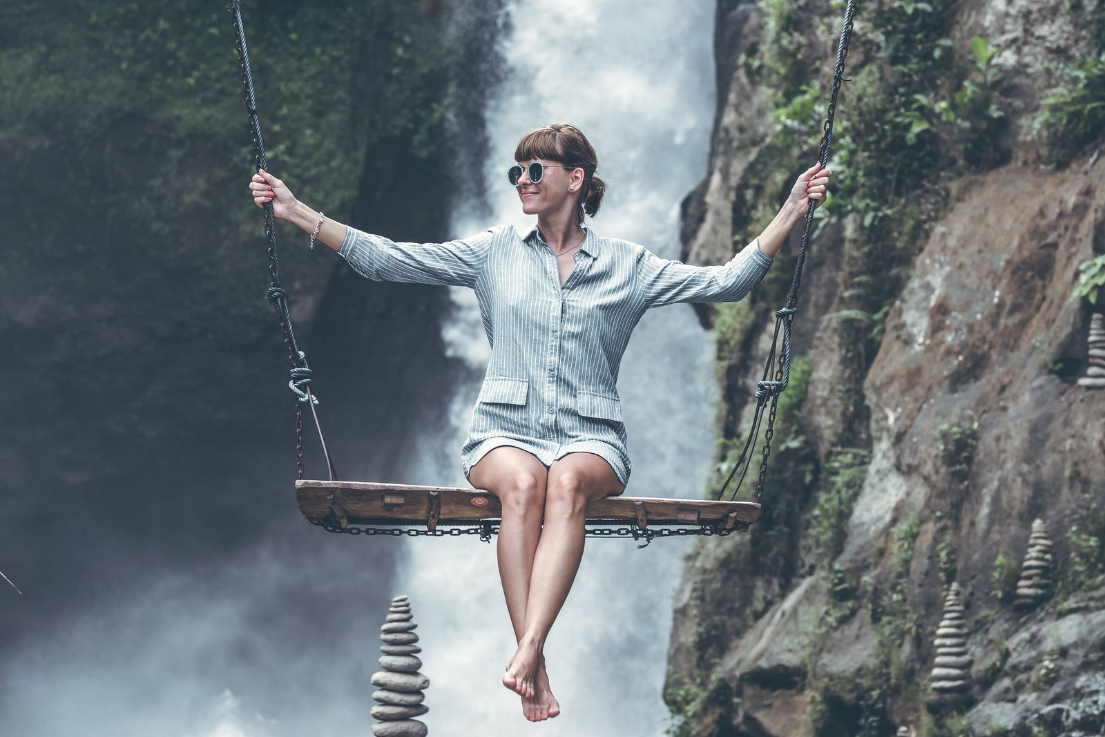 A waterfall dropping through dense jungle vegetation in Bali